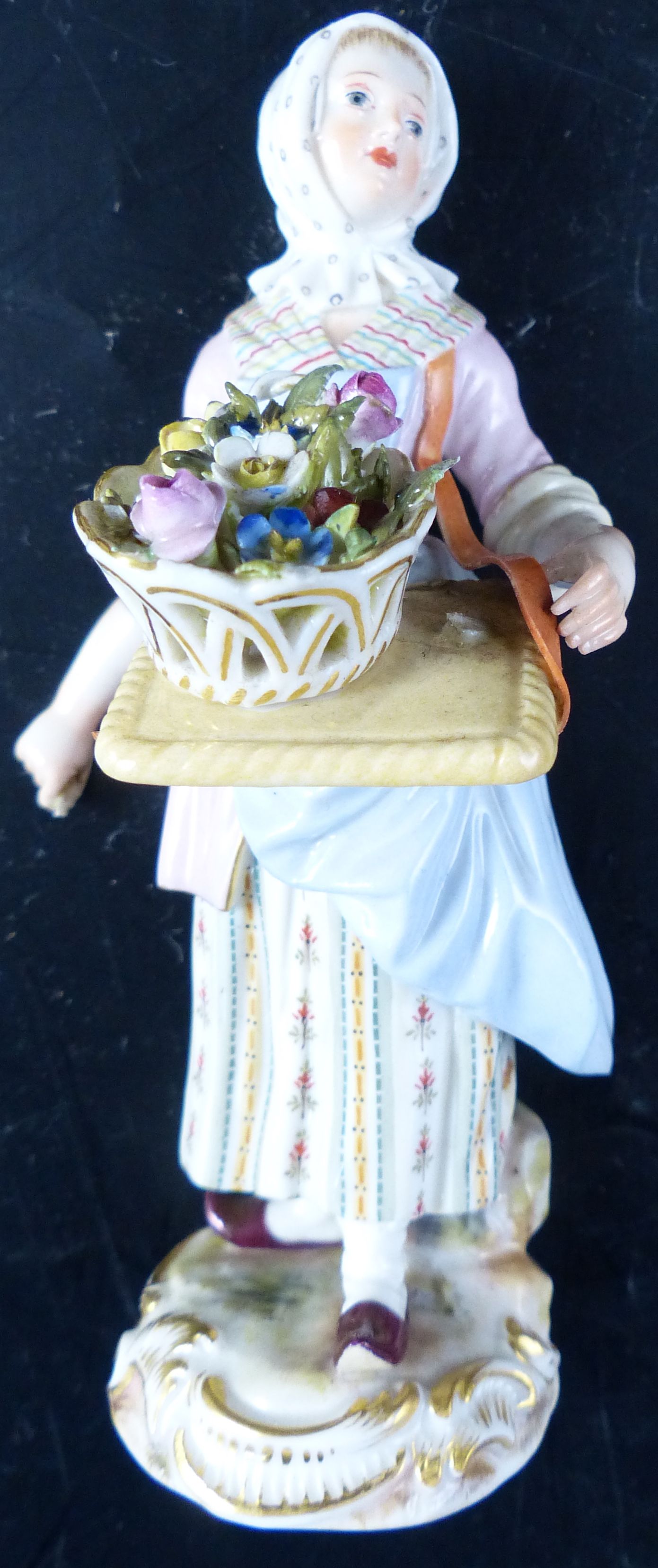 A pair of early 20th century Meissen figures of street vendors, 14cm (a.f.)
